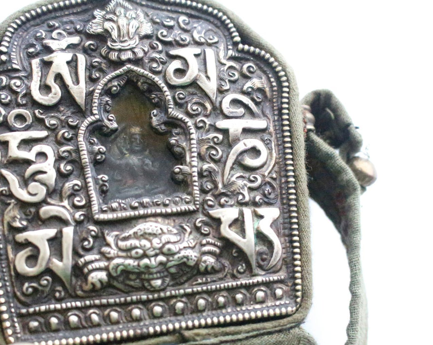 Hand Carved White Metal Manjushri Ghau Pendant - nepacrafts
