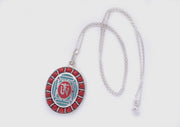 Coral Inlaid Buddha Eyes and Tibetan Om Painted White Metal Pendant - nepacrafts