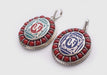 Coral Inlaid Buddha Eyes and Tibetan Om Painted White Metal Pendant - nepacrafts