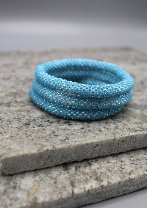 Shiny Light Blue Beads Nepalese Roll on Bracelet