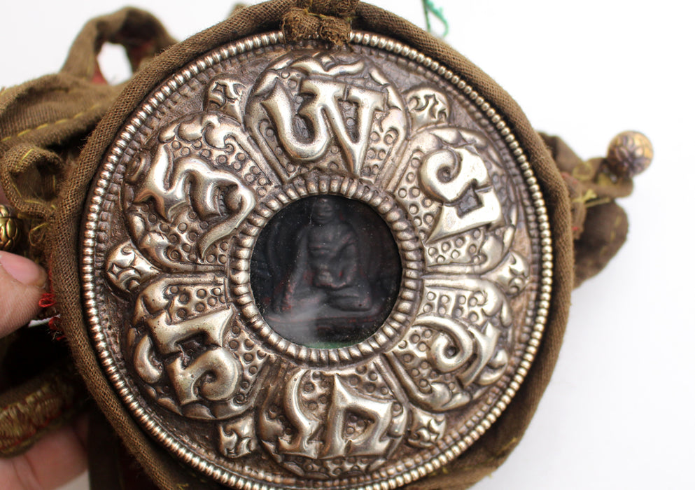 Om Mani Carved White Metal Shakyamuni Buddha Ghau Pendant in a Cotton Bag - nepacrafts
