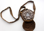 Round Hand Carved White Metal Manjushri Ghau Pendant with Cotton Cover - nepacrafts