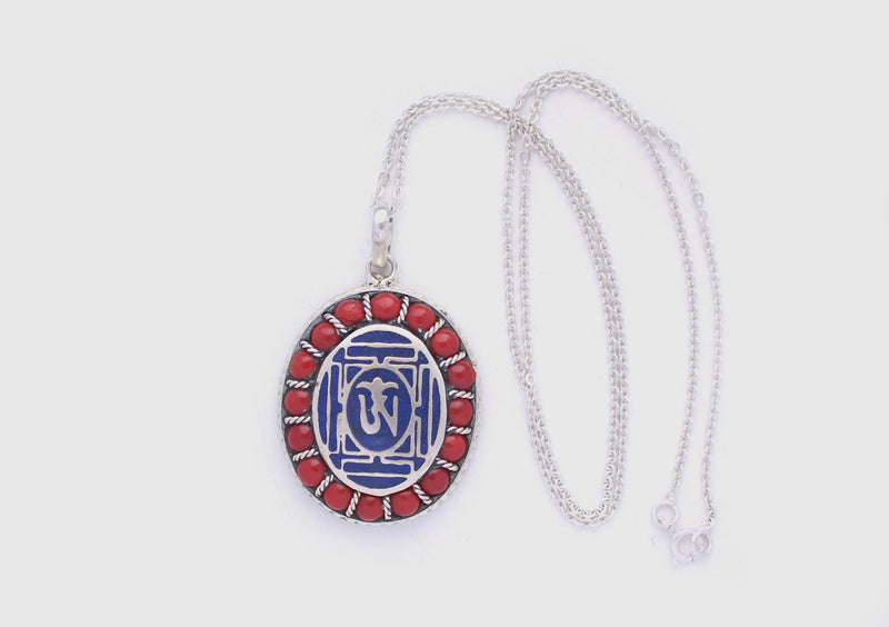 Coral Inlaid Buddha Eyes and Tibetan Om Painted White Metal Pendant - nepacrafts