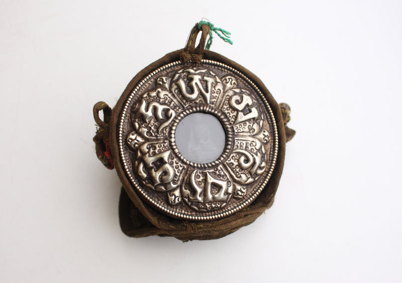Om Mani Carved White Metal Shakyamuni Buddha Ghau Pendant in a Cotton Bag - nepacrafts